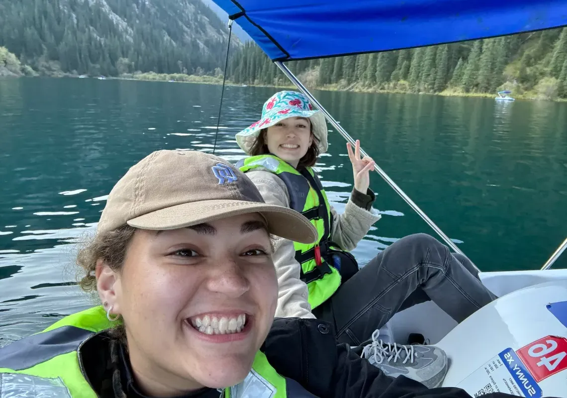 two Boren scholars kayaking on a mountain lake